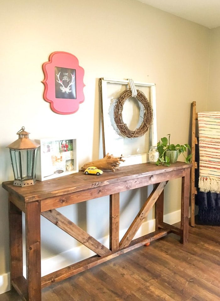 decorated console table made from 2x4 wood in entryway