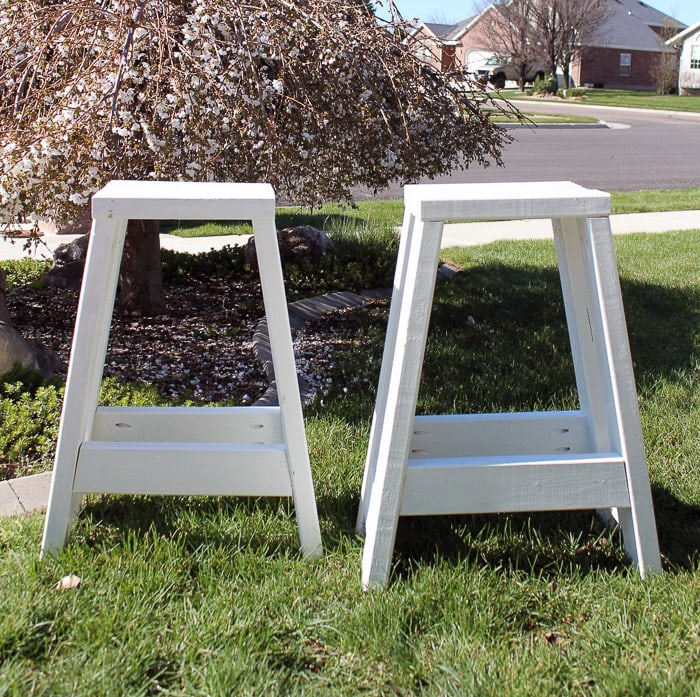 white DIY barstools made from 2x4 wood on grass 