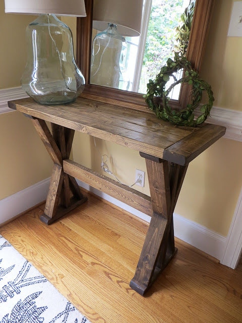 entryway console table with X-legs in an entryway.