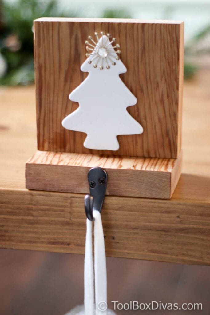 Scrap wood stocking holder with white Christmas tree on it
