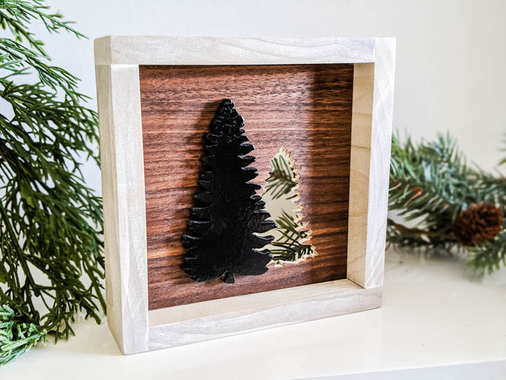 cut out Christamas tree made from scrap wood in a frame