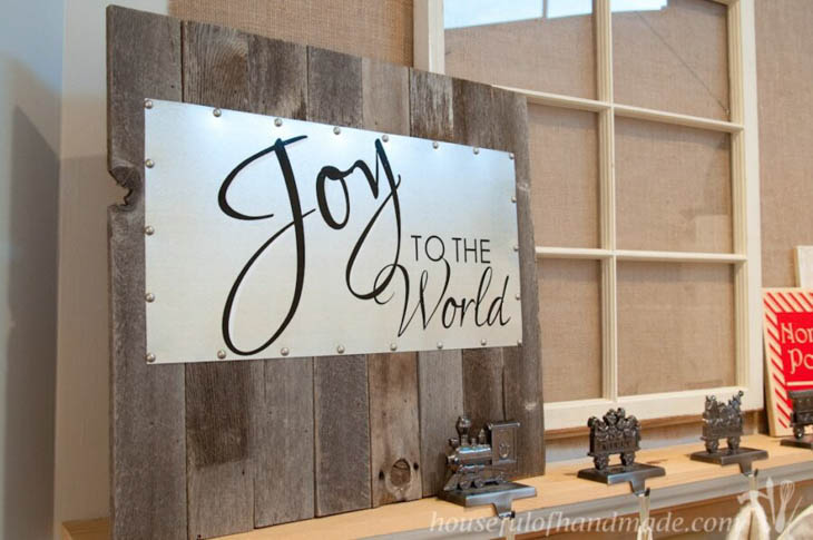 Joy to the world on metal mounted on scrap wood