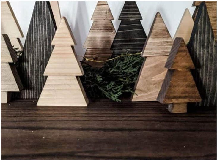 Scrap wood cut into the shape of Christmas trees and stained