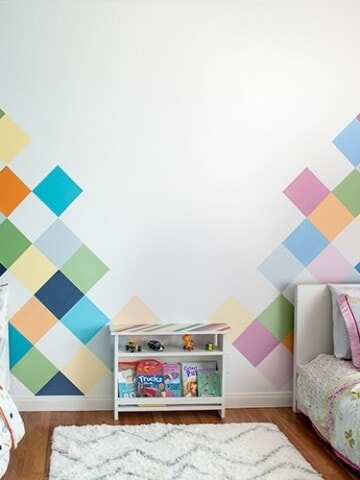 This colorful accent wall is perfect for kids room. Learn how to easily paint this DIY geometric accent wall in a couple of days and create the perfect feature wall.