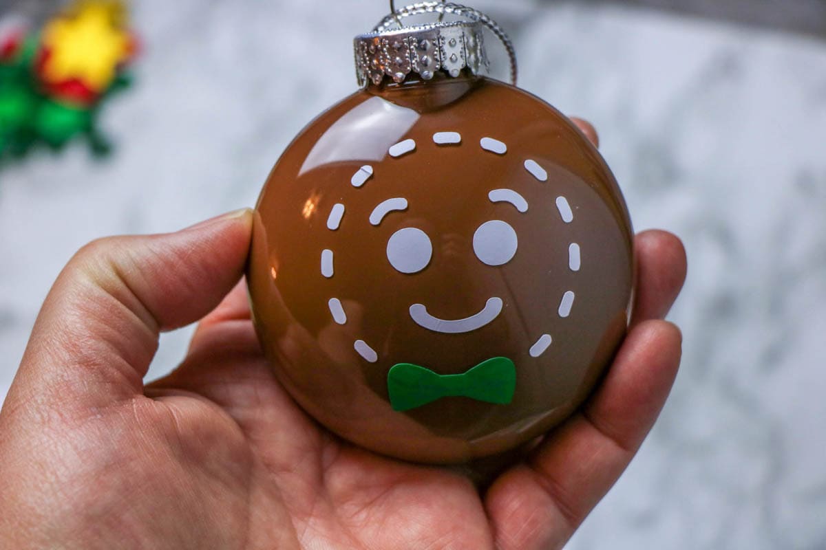 Round Christmas ornament with gingerbread man applied using a Cricut