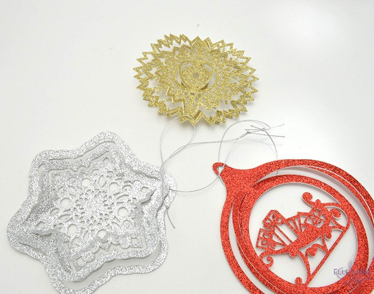 Gold, silver, and red ornaments made from paper