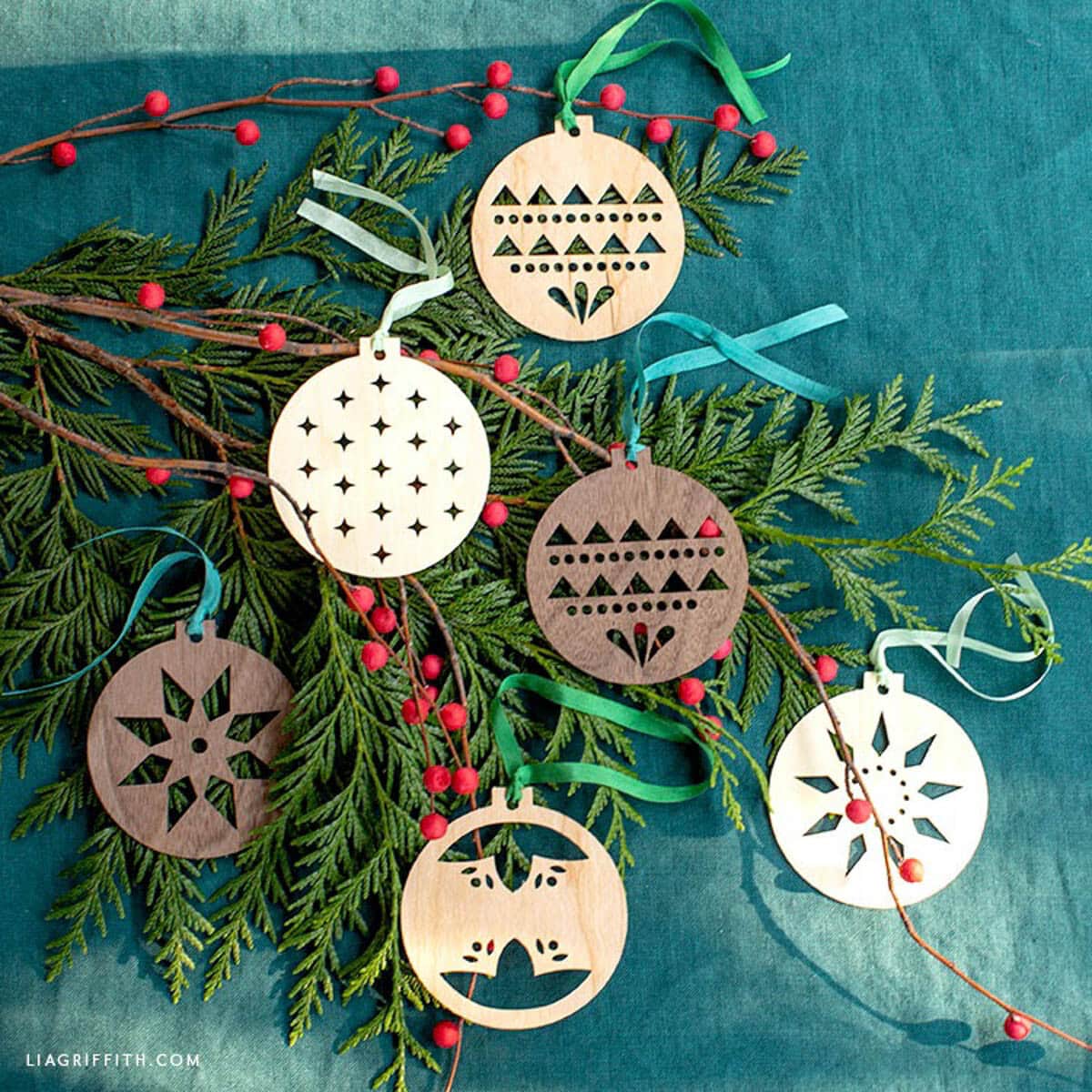 Assortment of six wood ornaments made with Cricut in a Scandinavian style