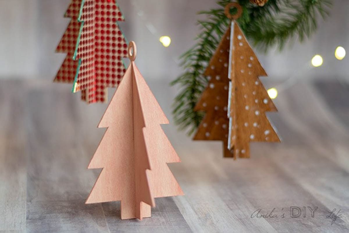 Three wooden Christmas tree Christmas ornaments made with a Cricut 