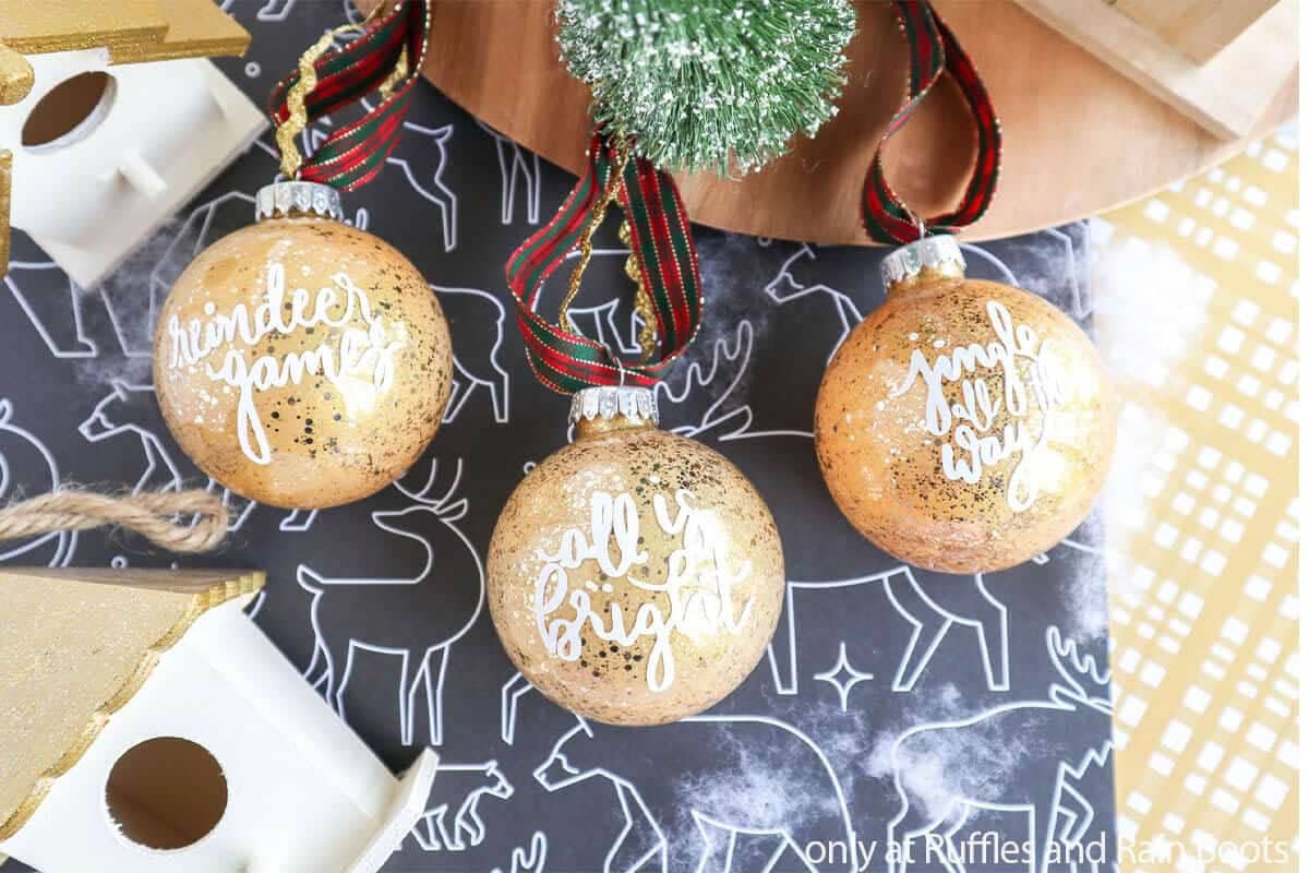 Gold glitter ornaments with holiday song lyrics