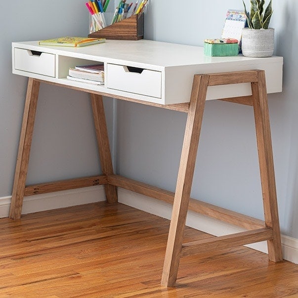 Learn how to build this DIY A-frame desk with drawers. This simple yet stylish wood desk is easy to make and makes any home office pop! Plus it uses only 4 power tools!