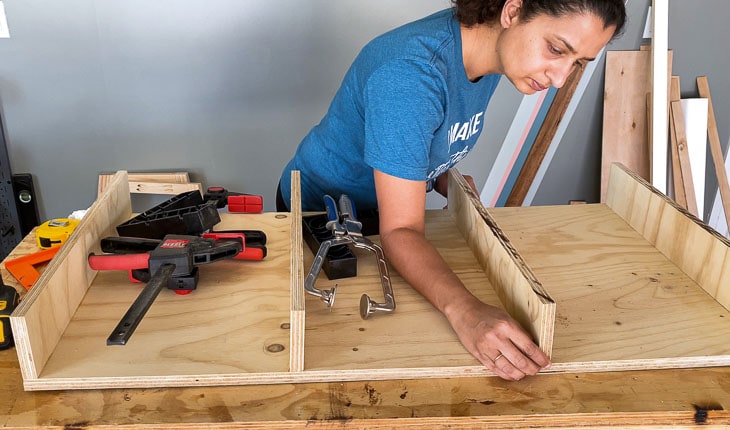 woman building the top frame of the desk