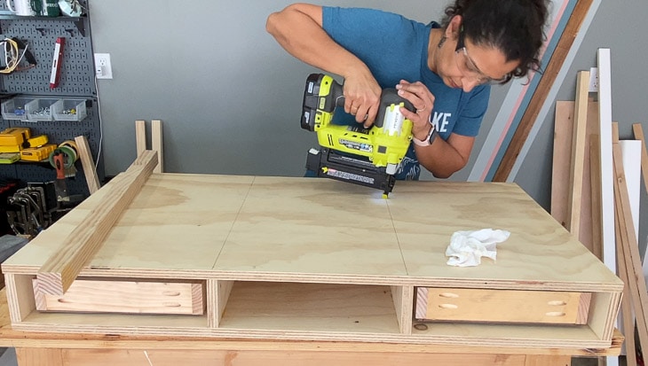 Attaching the top of the desk using brad nailer