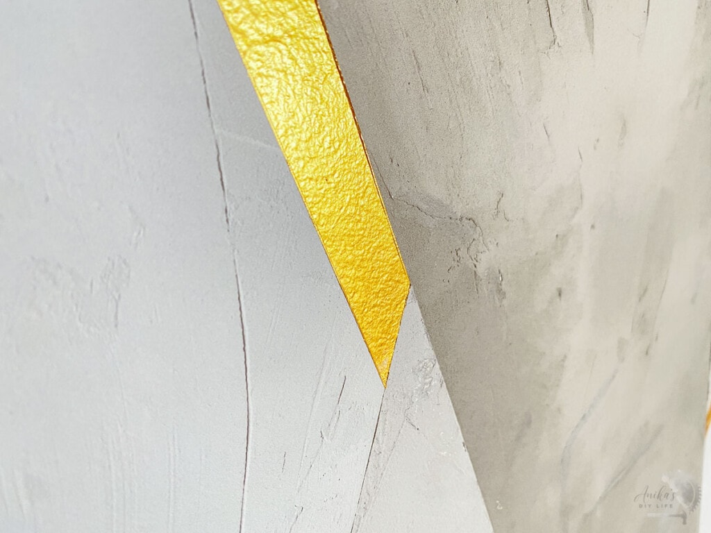 Close up of the gold and gray DIY cement feature wall