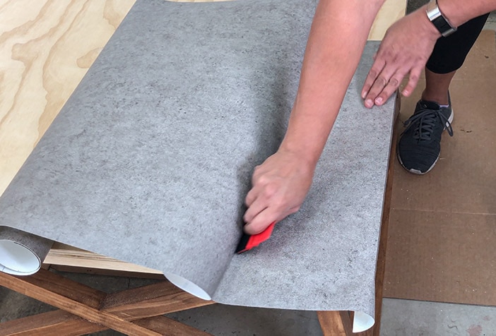 Applying concrete contact paper to the coffee table