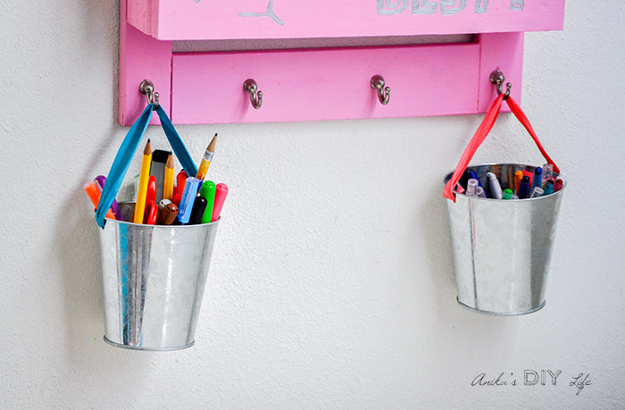Close up of supply buckets hanging from the DIY desk organizer
