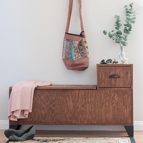 Build a DIY entryway bench with covered storage for shoes or jackets and a drawer to stash your keys or small items. Get the full printable plans.