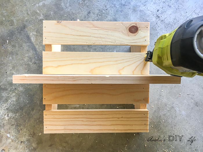 Using a scrap ¾" piece to attach slats on the DIY footrest for under the desk 
