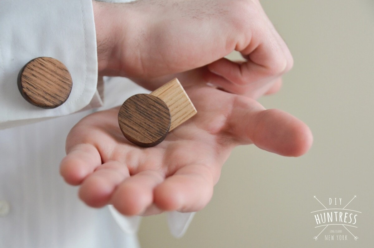 Man holding DIY wooden cuff link in his palm with the other on his sleeve