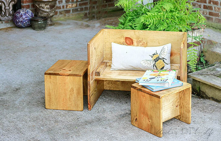 wood kids table and chairs with books and pillow 