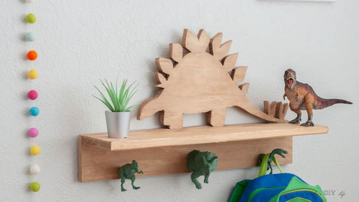 DIY wood dinosaur shelf with dinosaur figures as hooks 