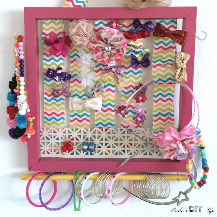 DIY girl's accessory holder painted pink with jewelry and hair accessories
