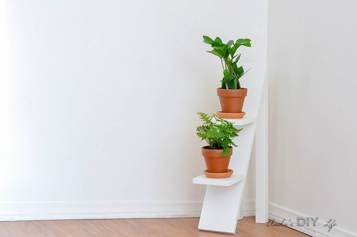 White tiered plant stand with two plants in terra cotta plants makes a great DIY gift for plant lovers