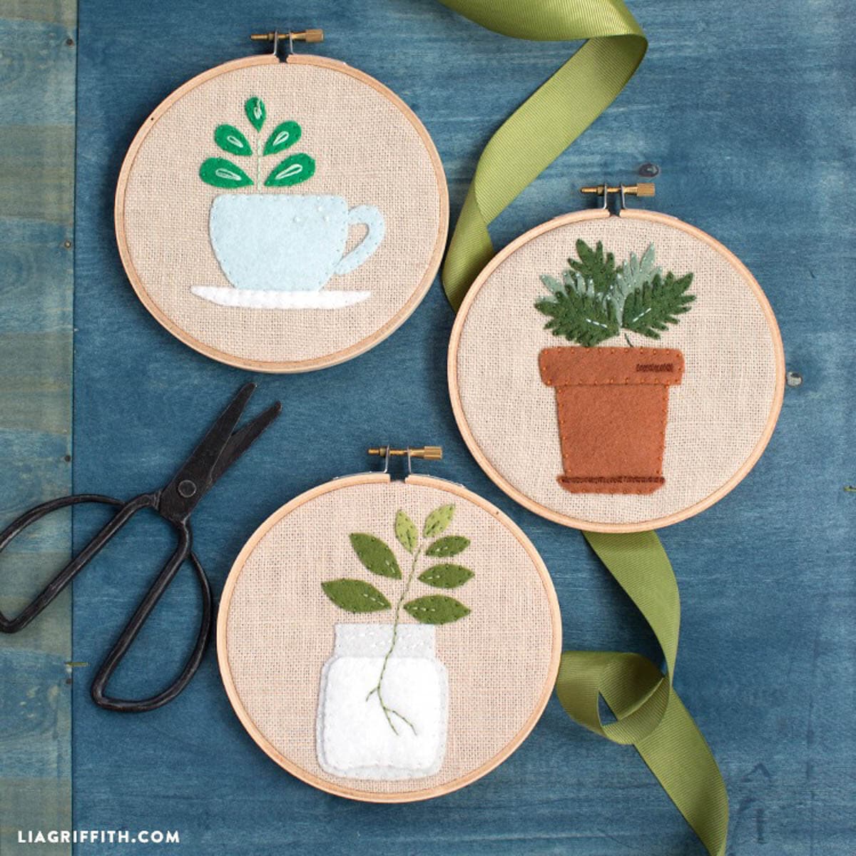 Three DIY embroidery hoops with plants pictured in felt