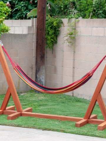 completed DIY hammock stand sitting in grassy corner of yard