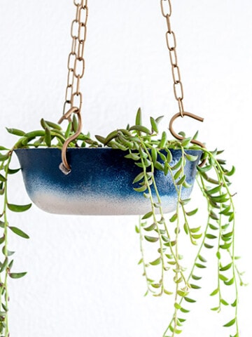Learn how to make a DIY hanging concrete planter and give it a pretty ombre effect using Rust-Oleum spray paint. It makes the perfect hanging planter for any room.
