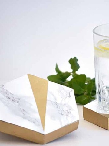 DIY hexagonal marble and gold coasters with glass of water