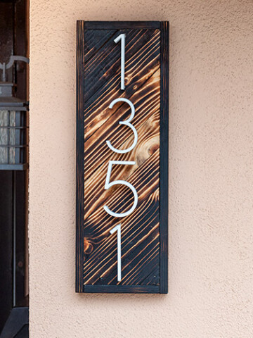 DIY house number sign with gradient wood burning on the wall