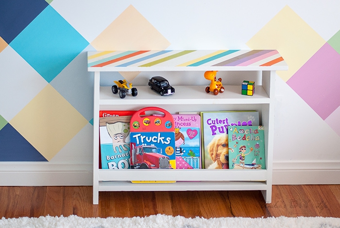 Colorful kids bedside table with books and toys in a colorful room.