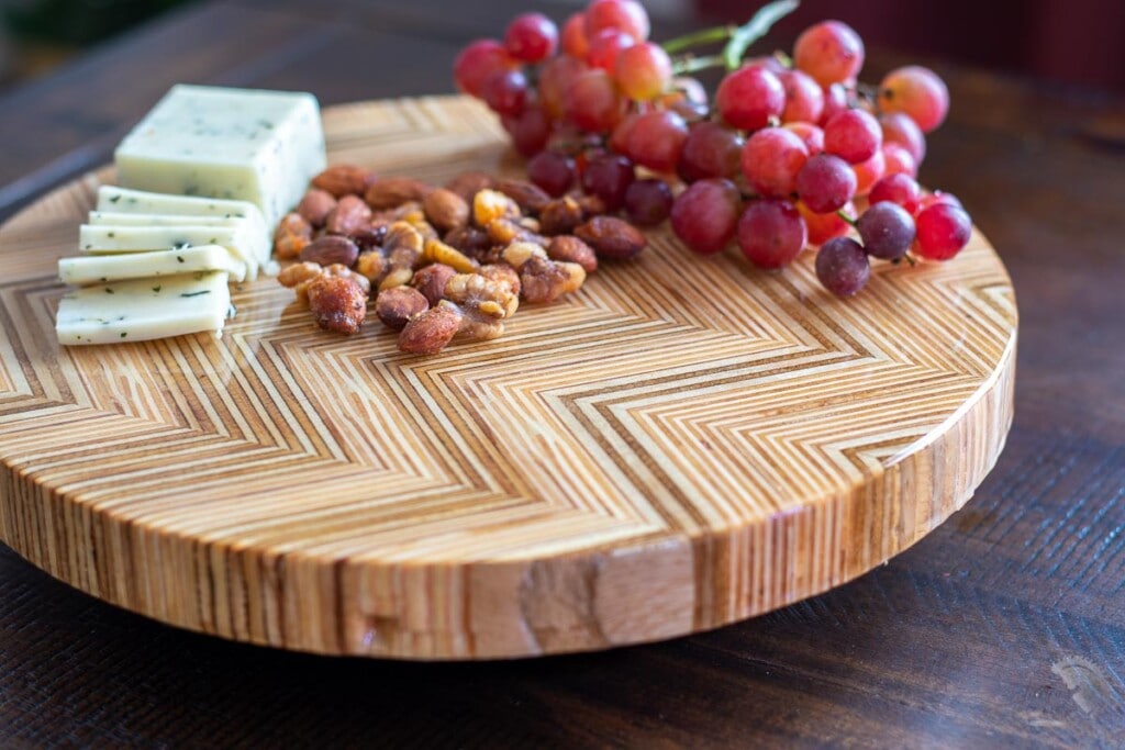 DIY Lazy Susan using Patterned Plywood with cheese , nuts and grapes on dining table