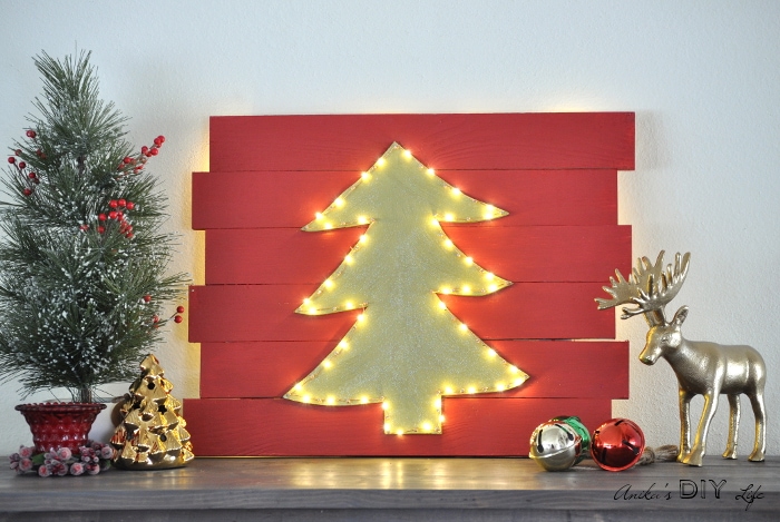 LED lit Christmas tress silhouette on red slatted background