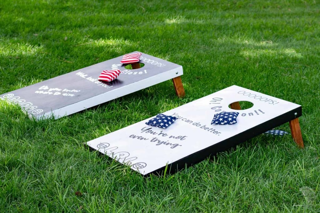 Black and while corn hole board in the grass