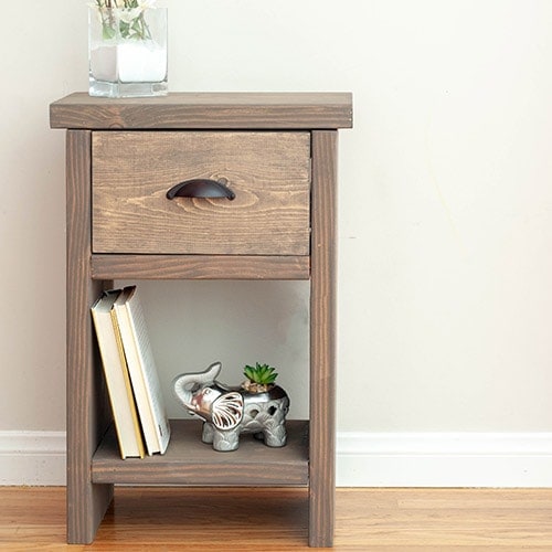 Learn how to build a DIY nightstand with hidden compartment and a drawer with the full step by step tutorial, video and plans. Easy beginner woodworking project using concealed joints!