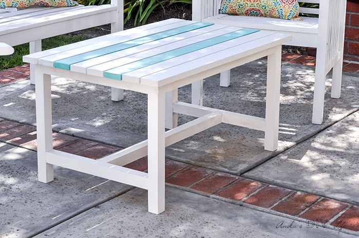 Close up white DIY outdoor coffee table with aqua stripes