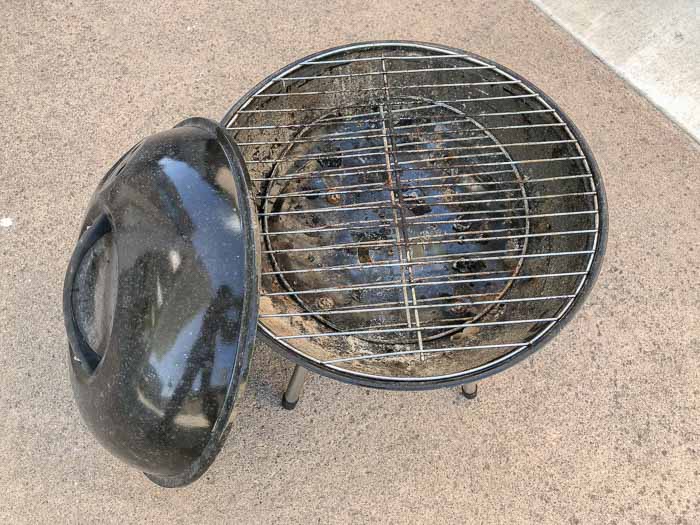 Old charcoal grill with crud and grime