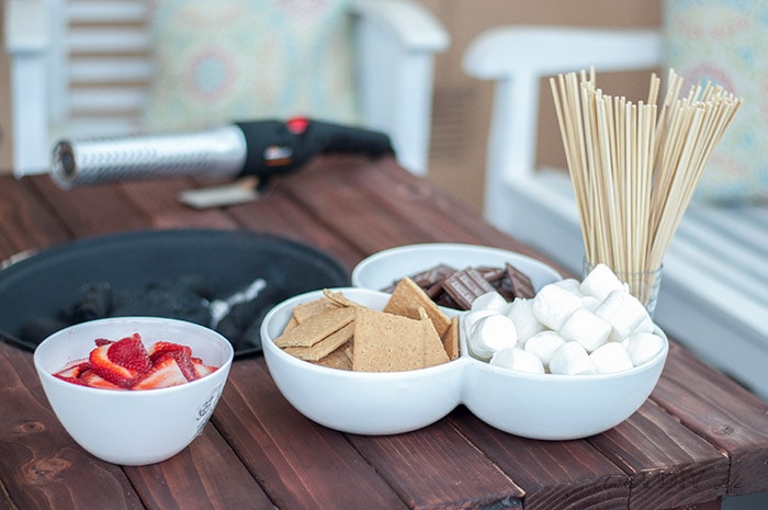 Smores ingredients on a DIY patio table with fire pit and the HomeRight Electrolight fire starter