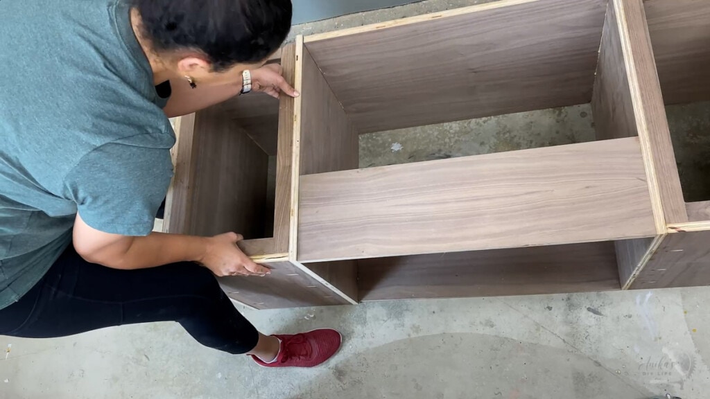 woman building the inside of the record player stand
