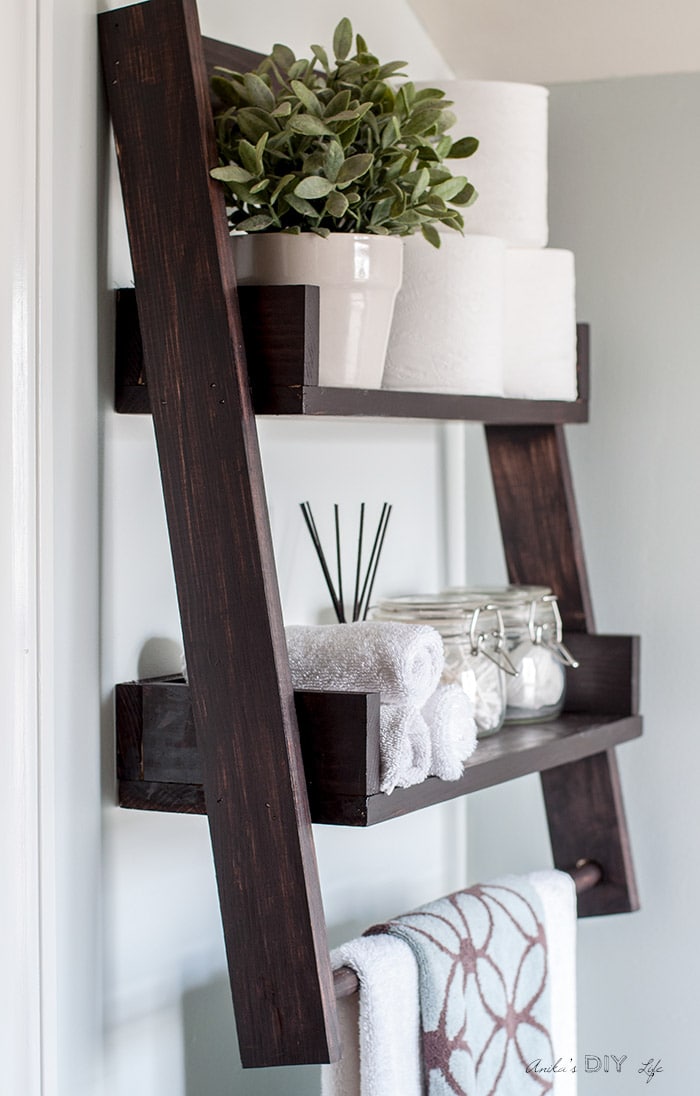 Full view of the DIY floating ladder shelf mounted on the wall.