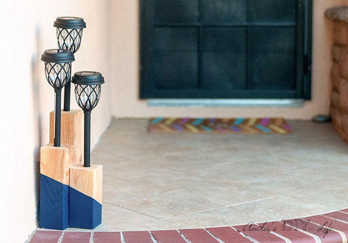 DIY solar light post with blue paint on front steps