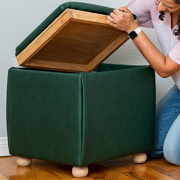 Learn how to build a DIY storage ottoman cube from scratch. The top has a reversible tray. The upholstered ottoman is a super easy build with no sewing involved!