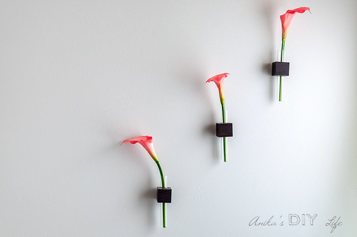 All three test tube bud vases on the wall with cala Lilies in them