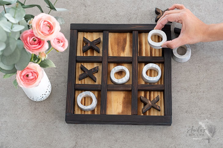Woman playing tic-tac-toe on a coffee table