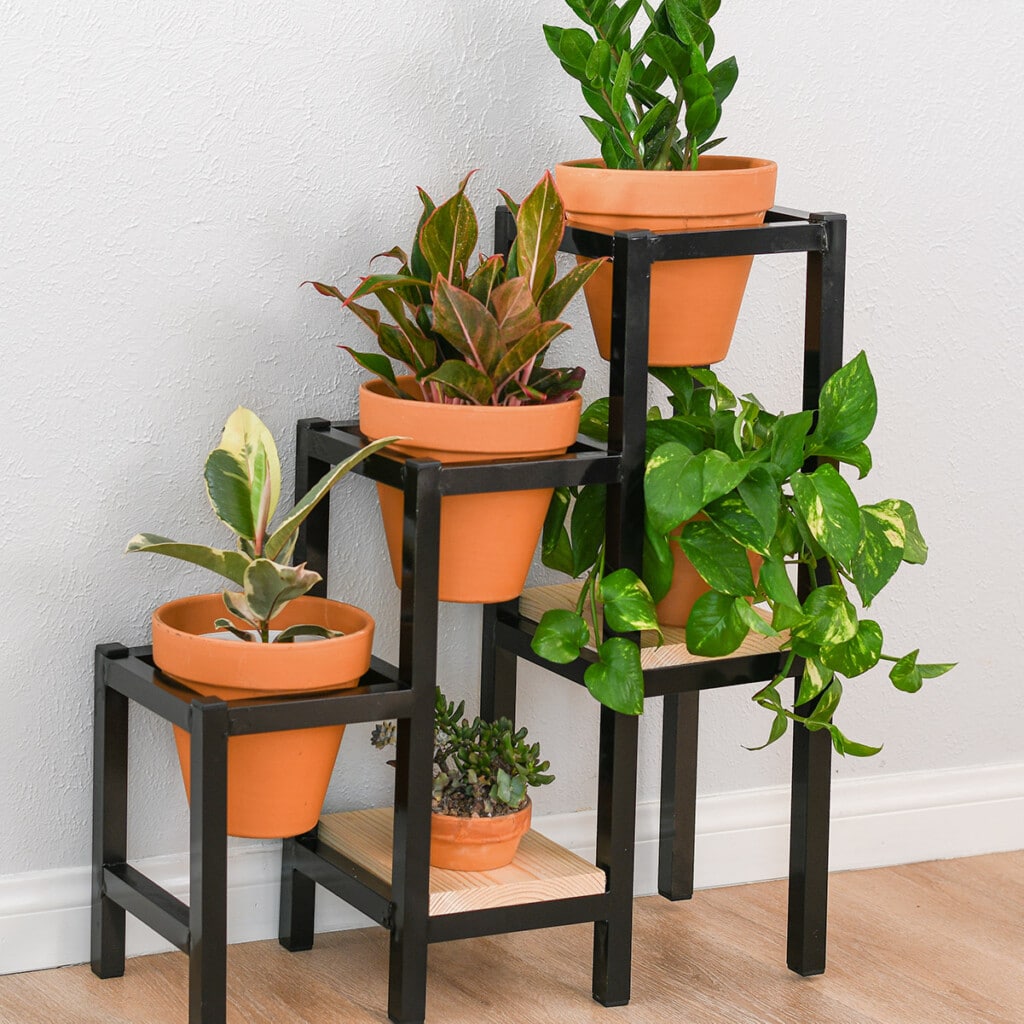 Learn how to build a DIY tiered metal plant stand using aluminum brazing with a blow torch with detailed tutorial, video and plans. It makes a great display for all your plants!