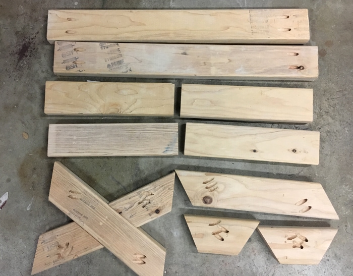 2x4 boards cut for the DIY bench on the garage floor