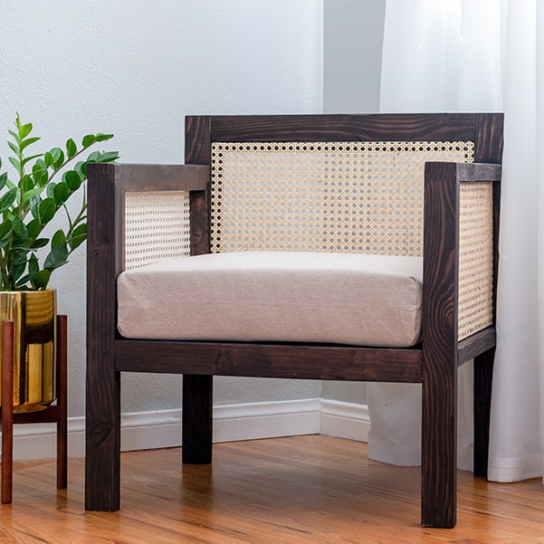 Learn how to make a DIY wooden chair with cane webbing back and arms with the step-by-step tutorial and plans. This DIY armchair makes the perfect addition to any living room.
