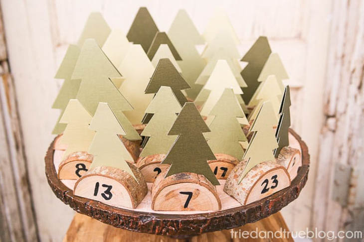 Advent calendar made with paper trees and wood slice bases