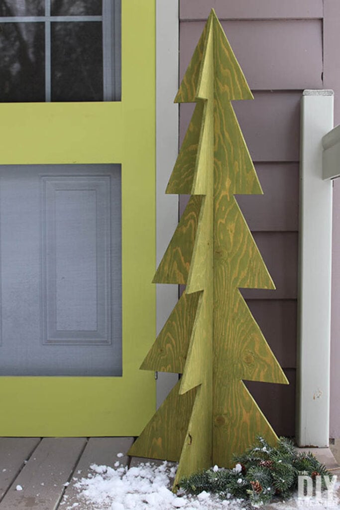 Light green plywood 3D Christmas tree on front porch